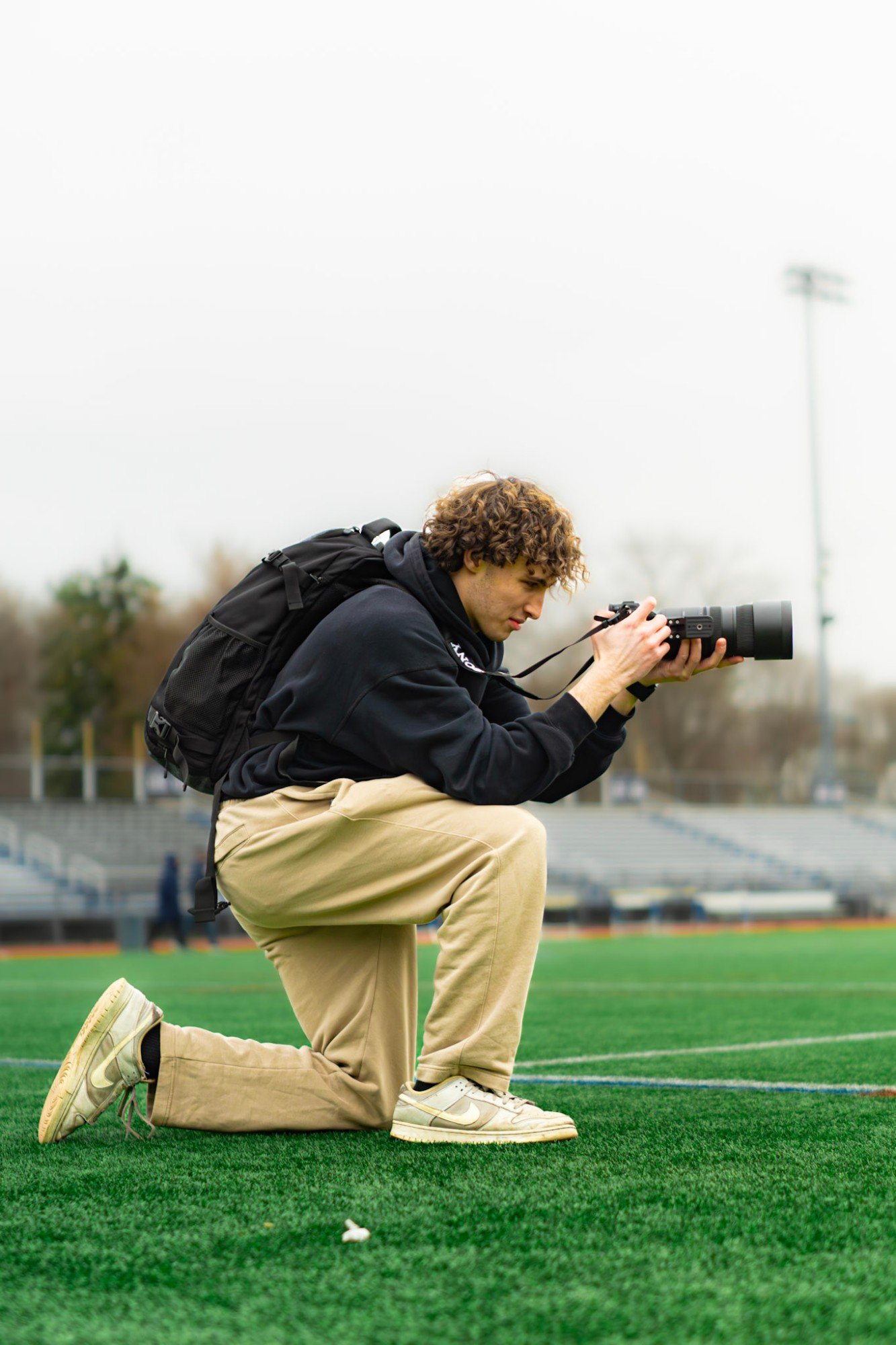 Brennen Moquin photographing on the field